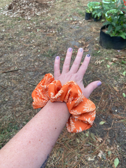 orange flower scrunchie on arm