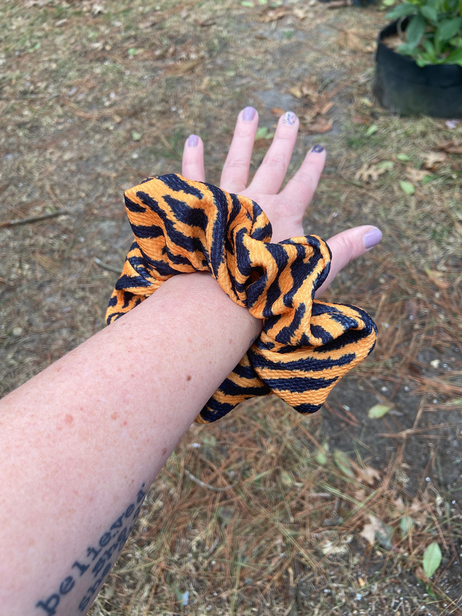 Orange and Black Tiger Stripe Scrunchie on wrist