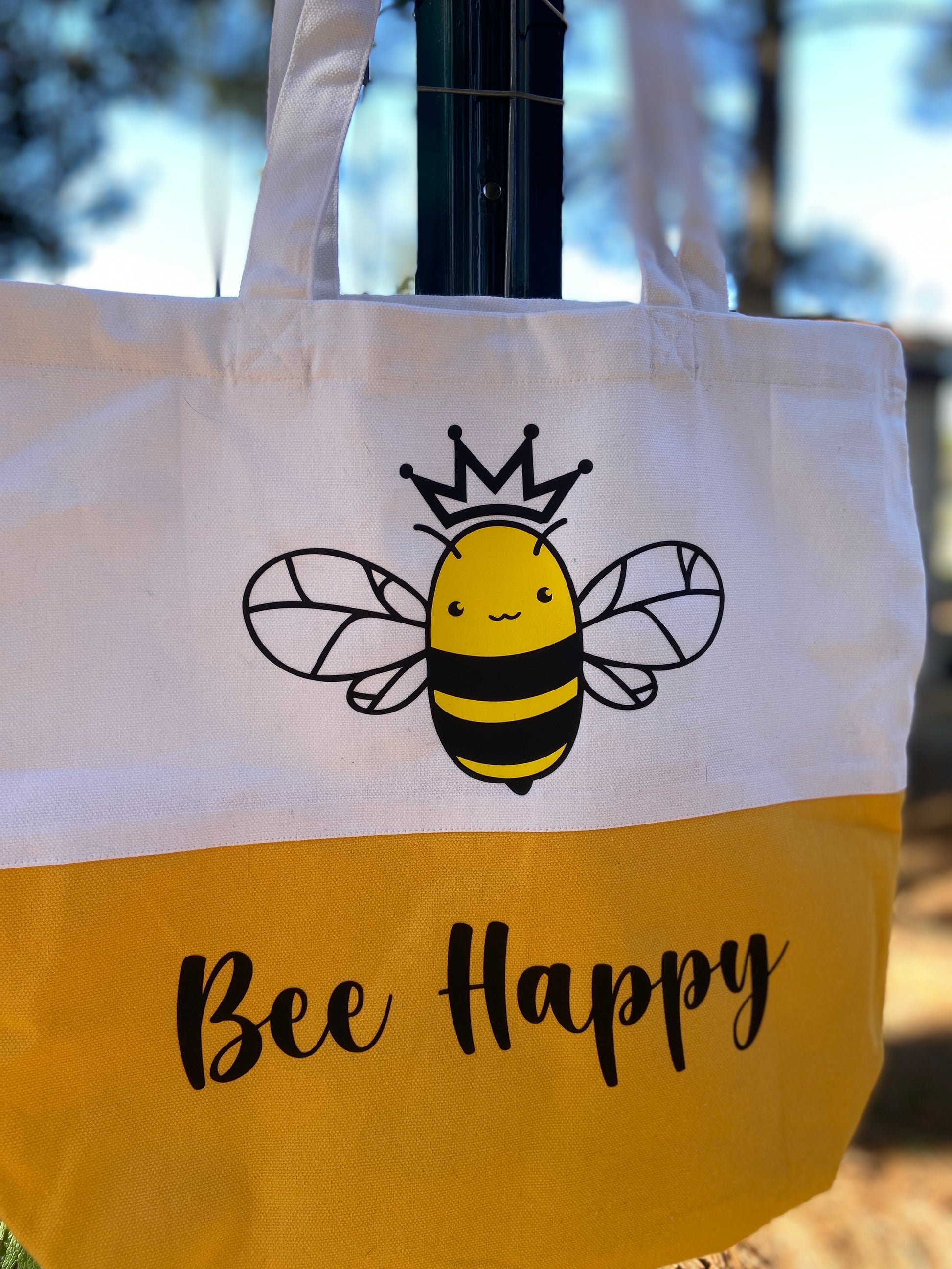 White and Yellow Honeybee wearing a crown tote bag