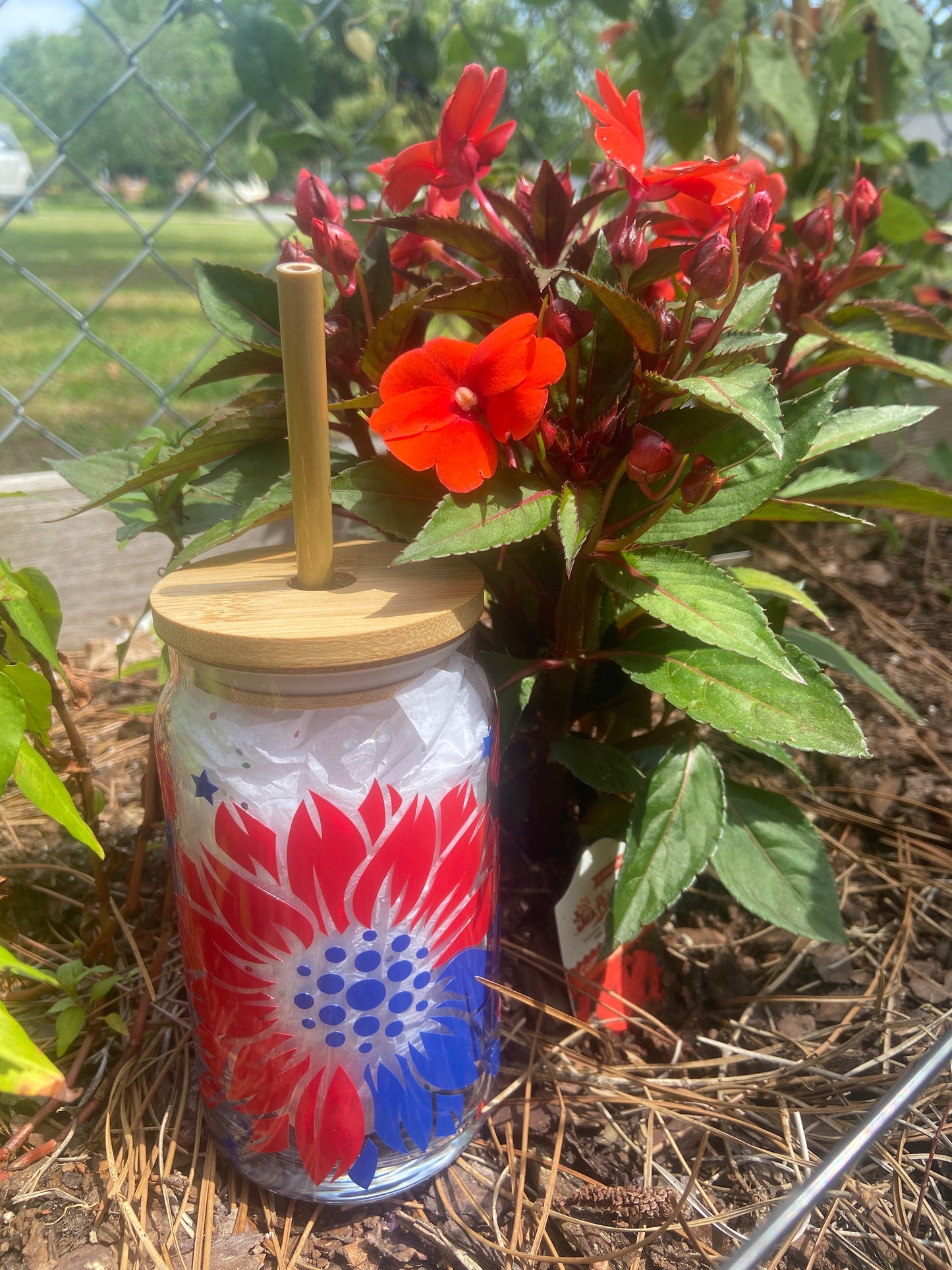 patriotic sunflower beer glass next to flowers