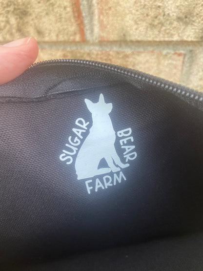 sugar bear farm logo on black makeup bag